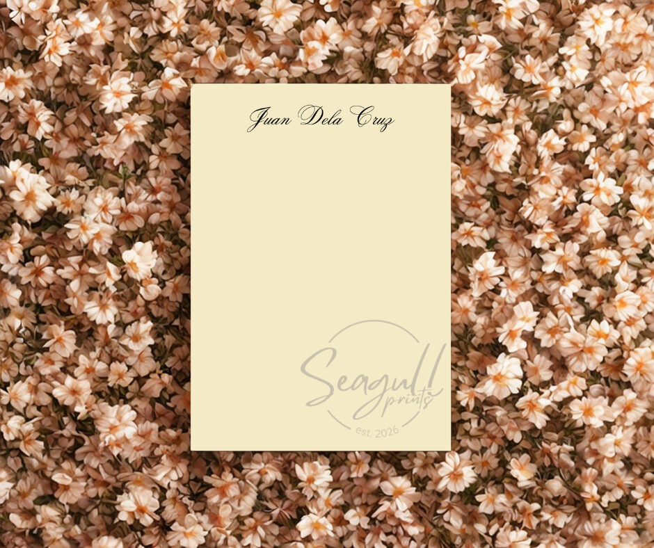 Close-up of the cream-colored textured paper on a memo pad, showing the high-quality grain and clean minimalist binding.
